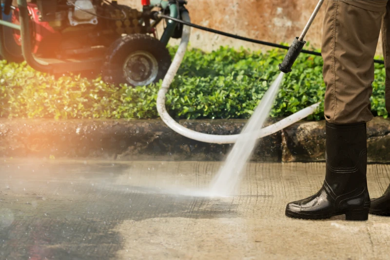 Power washing a sidewalk
